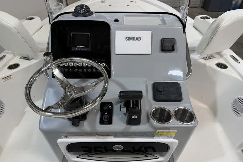 Slide: The Image of Center console of a 2026 Sea Pro 210 Bay boat with steering wheel and controls. - 11