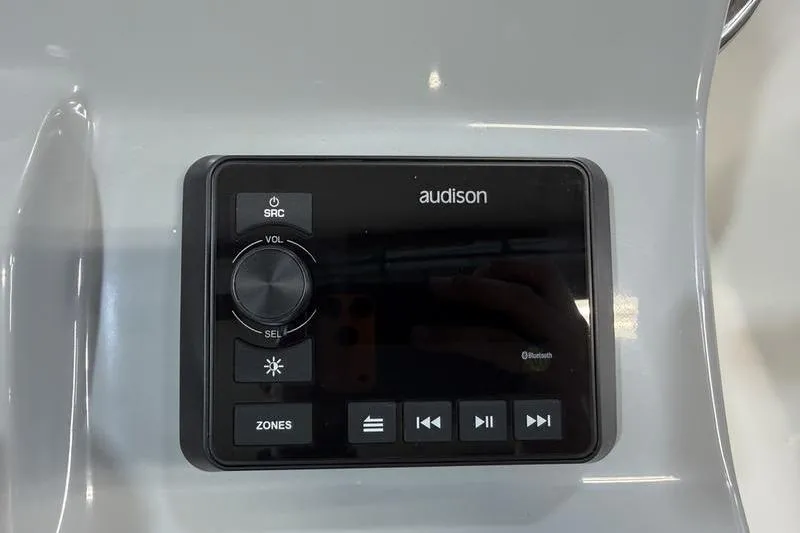 Slide: The Image of Audison audio control panel on 2026 Sea Pro 210 Bay boat dashboard. - 14