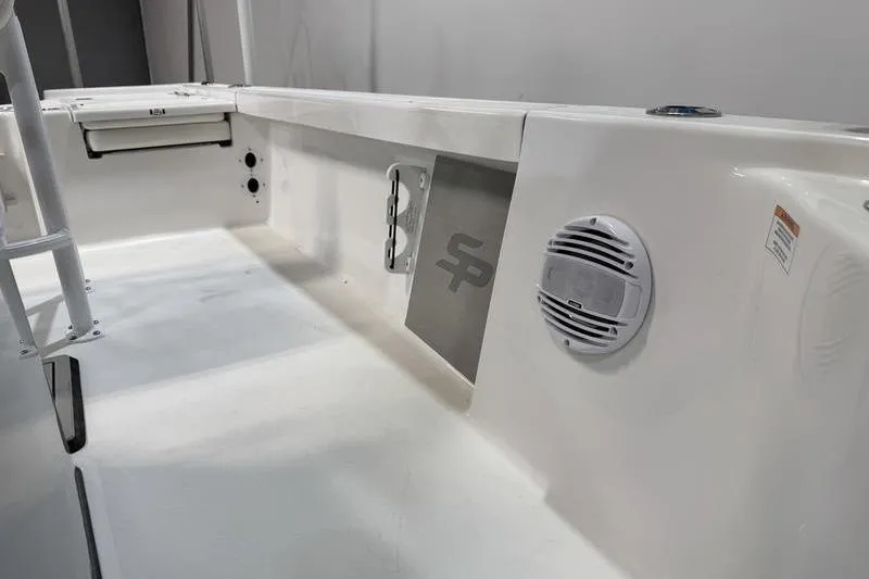 Slide: The Image of 2026 Sea Pro 210 Bay boat interior with speaker and storage compartment. - 19