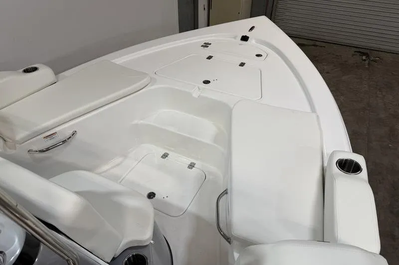 Slide: The Image of 2026 Sea Pro 210 Bay boat interior with white seating and storage compartments. - 20
