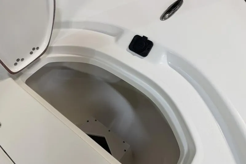 Slide: The Image of 2026 Sea Pro 210 Bay boat storage compartment with open hatch, showcasing interior space. - 22