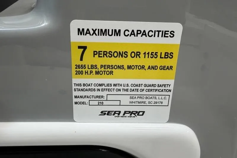 Slide: The Image of 2026 Sea Pro 210 Bay boat capacity label: 7 persons or 1155 lbs, 200 HP motor. - 23