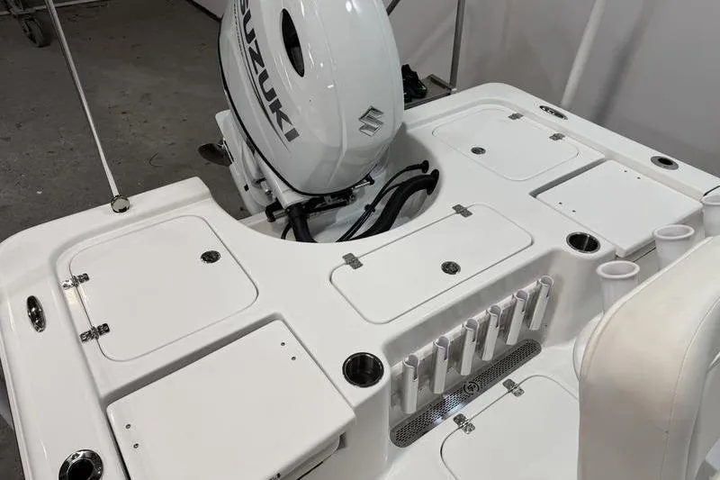 Slide: The Image of 2026 Sea Pro 210 Bay boat with Suzuki outboard motor, featuring storage compartments and rod holders. - 7
