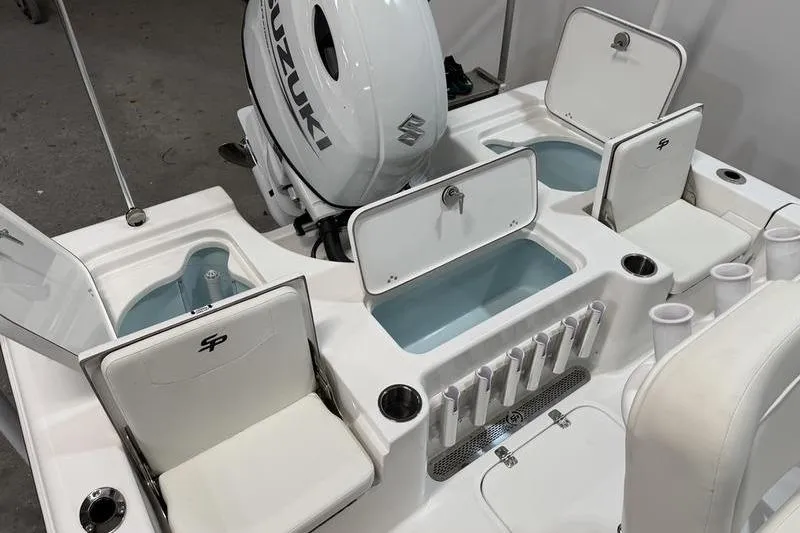 Slide: The Image of 2026 Sea Pro 210 Bay boat interior with Suzuki engine, featuring storage compartments and seating. - 8