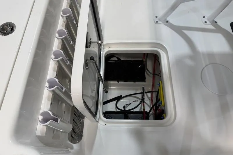 Slide: The Image of Open hatch on 2026 Sea Pro 210 Bay boat showing storage and wiring. - 9
