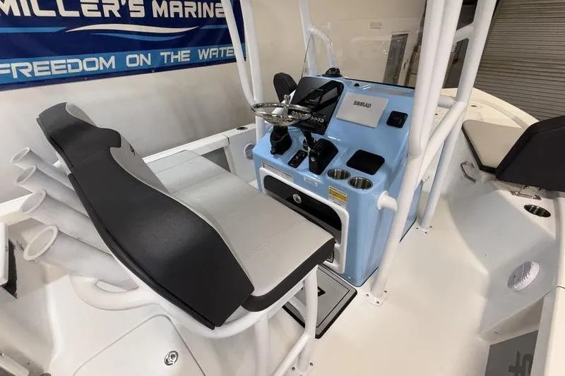 Slide: The Image of 2026 Sea Pro 210 Bay boat interior with helm, seating, and controls. - 10