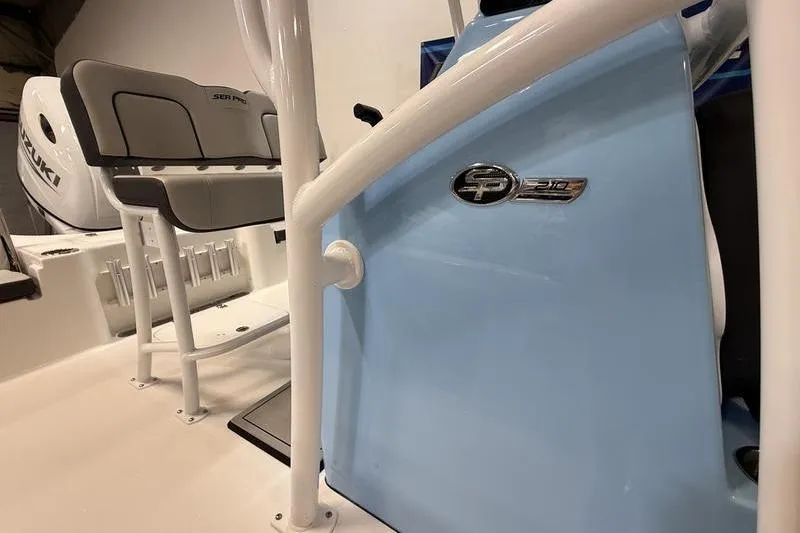 Slide: The Image of 2026 Sea Pro 210 Bay boat interior with seating and console details. - 16