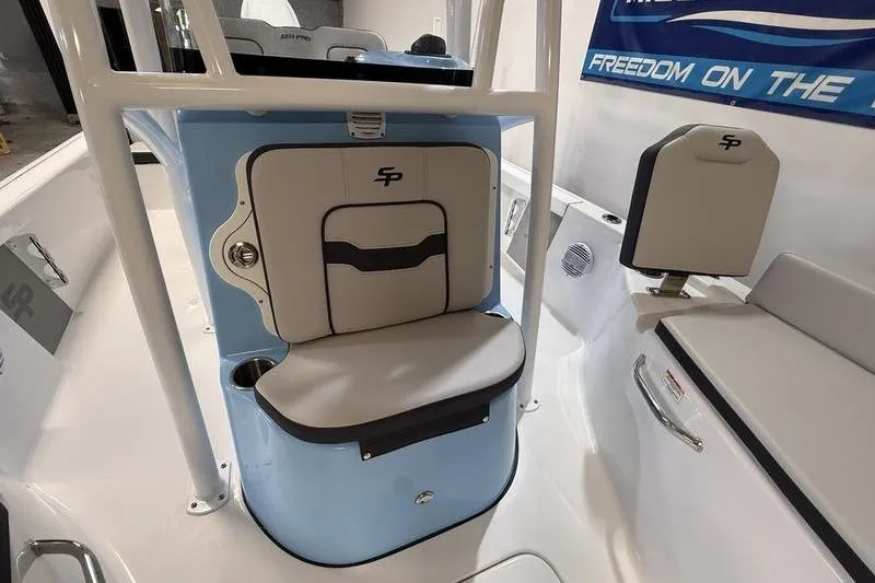 Slide: The Image of 2026 Sea Pro 210 Bay boat interior with seating and storage features. - 17