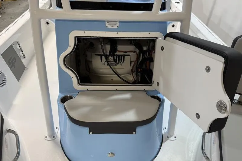 Slide: The Image of 2026 Sea Pro 210 Bay boat interior with open storage compartment. - 18