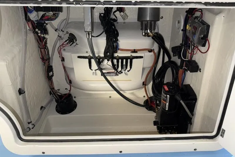 Slide: The Image of Electrical and mechanical components inside a 2026 Sea Pro 210 Bay boat compartment. - 19