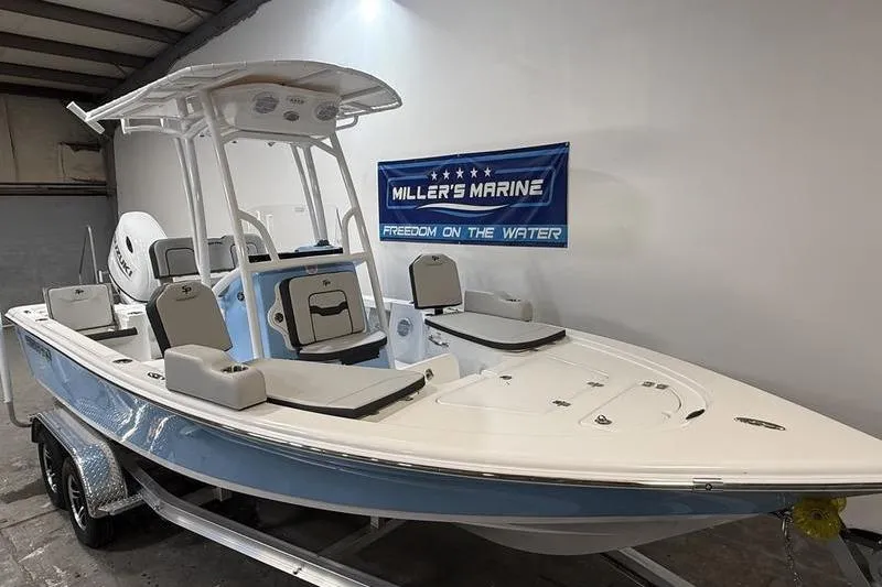 Slide: The Image of 2026 Sea Pro 210 Bay boat displayed at Miller's Marine showroom. - 2