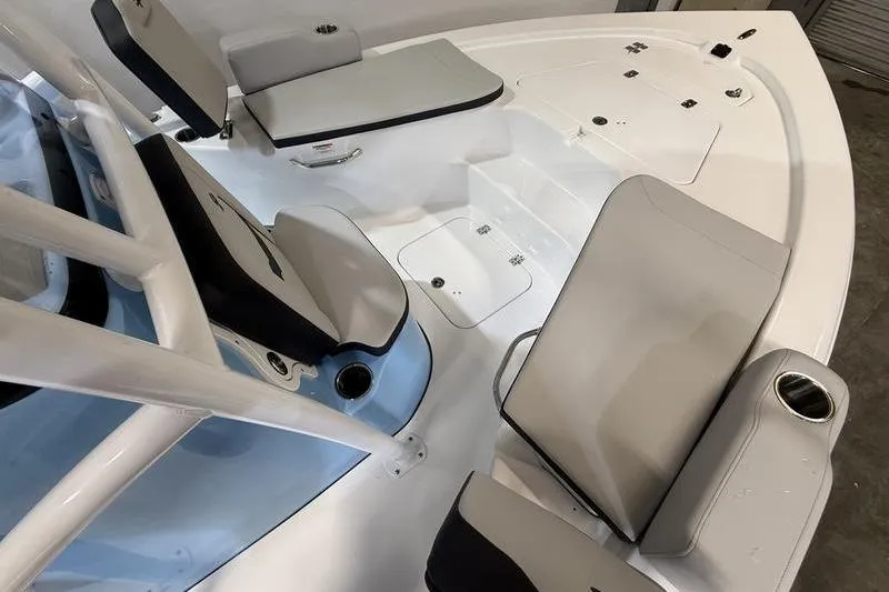 Slide: The Image of 2026 Sea Pro 210 Bay boat interior with cushioned seating and storage compartments. - 21