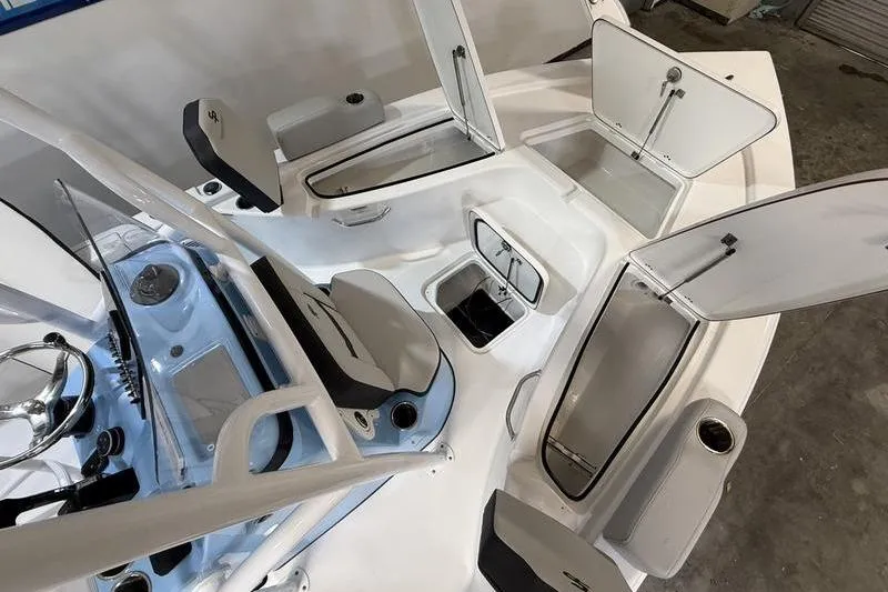 Slide: The Image of 2026 Sea Pro 210 Bay boat interior with open storage compartments and seating. - 22
