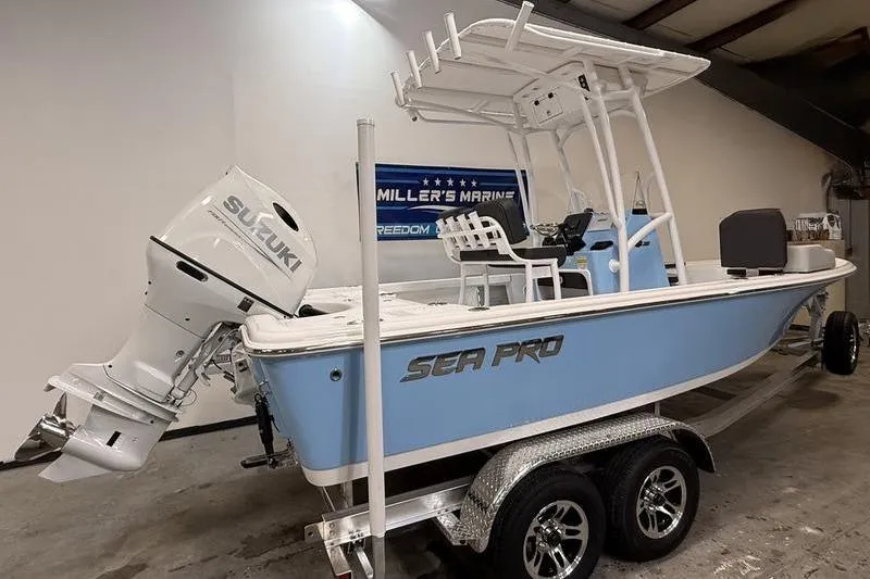 Slide: The Image of 2026 Sea Pro 210 Bay boat with Suzuki engine on trailer in showroom. - 3