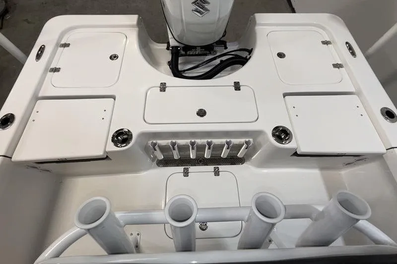 Slide: The Image of 2026 Sea Pro 210 Bay boat deck with storage compartments and rod holders. - 5