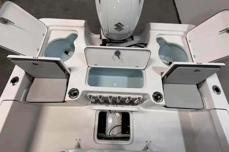 Slide: The Image of 2026 Sea Pro 210 Bay boat deck with storage compartments and Suzuki engine. - 6