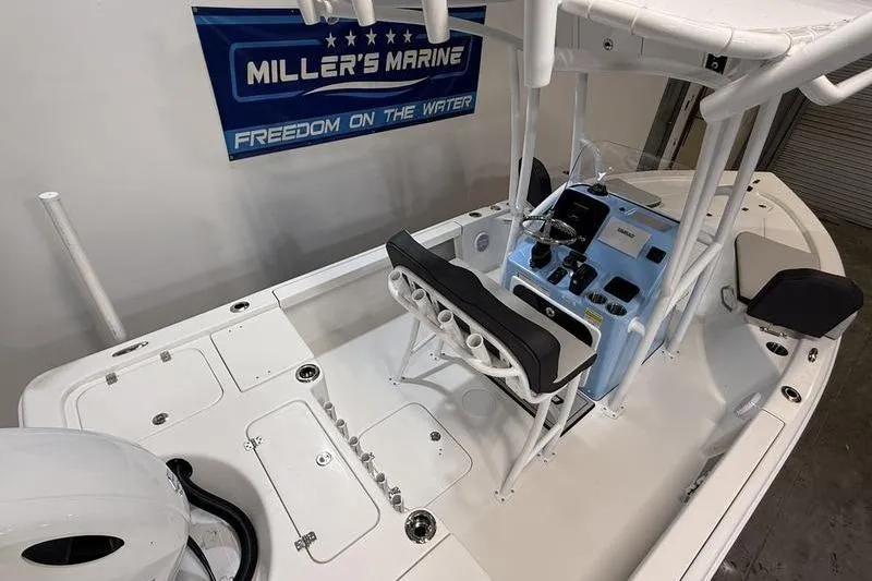 Slide: The Image of 2026 Sea Pro 210 Bay boat interior with console and seating, displayed at Miller's Marine. - 8