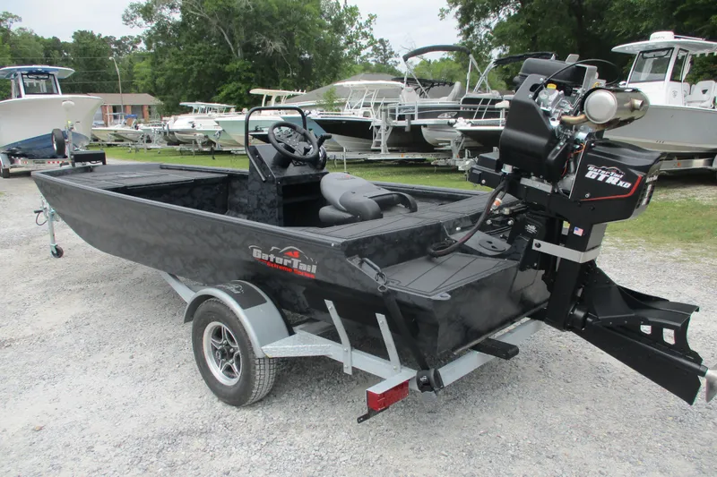 Slide: The Image of 2026 Gator Tail 1860 Extreme CC boat on trailer, parked in a marina lot. - 6