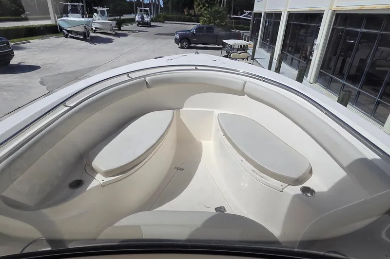 Slide: The Image of 2010 Pursuit S 280 Sport boat interior with cushioned seating and spacious deck area. - 10