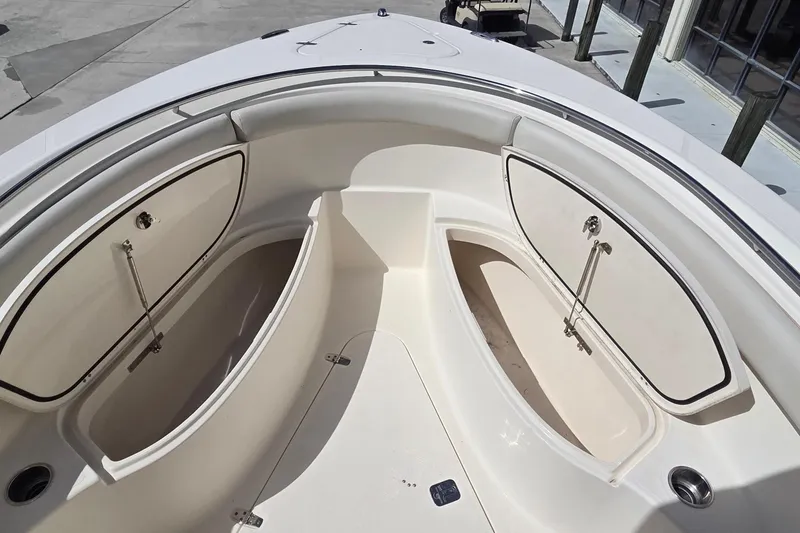 Slide: The Image of 2010 Pursuit S 280 Sport boat interior with open storage compartments. - 11