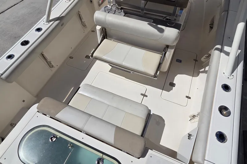 Slide: The Image of 2010 Pursuit S 280 Sport boat interior with cushioned seating and storage compartments. - 12