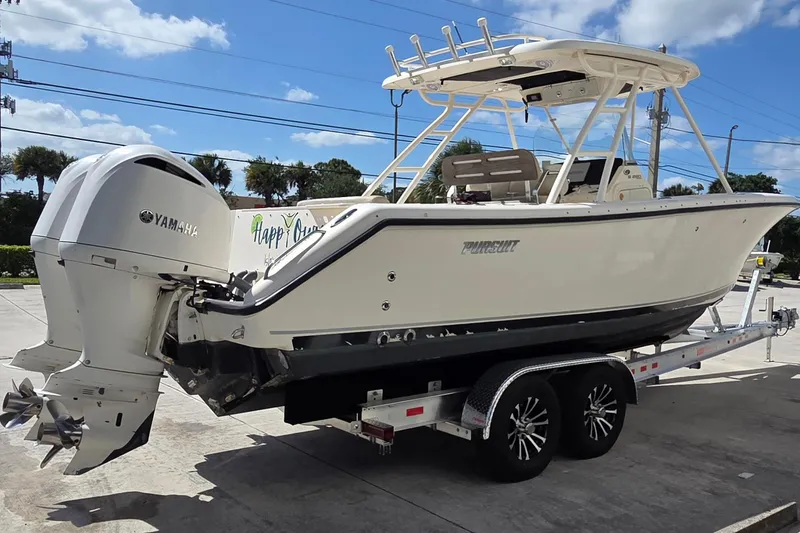 Slide: The Image of 2010 Pursuit S 280 Sport boat on trailer with Yamaha engines, parked outdoors. - 5
