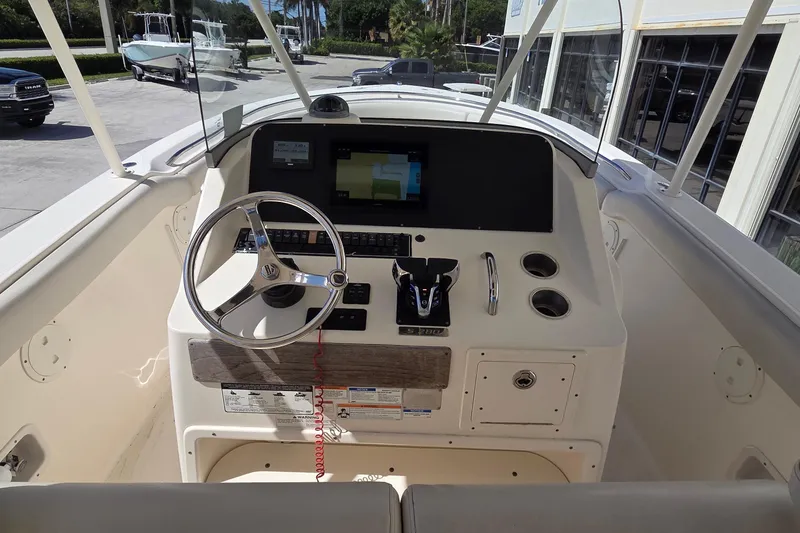 Slide: The Image of 2010 Pursuit S 280 Sport boat cockpit with steering wheel and navigation display. - 7