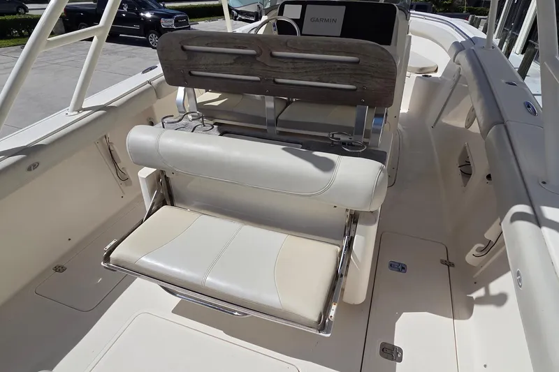 Slide: The Image of 2010 Pursuit S 280 Sport boat interior with white seating and Garmin equipment. - 9