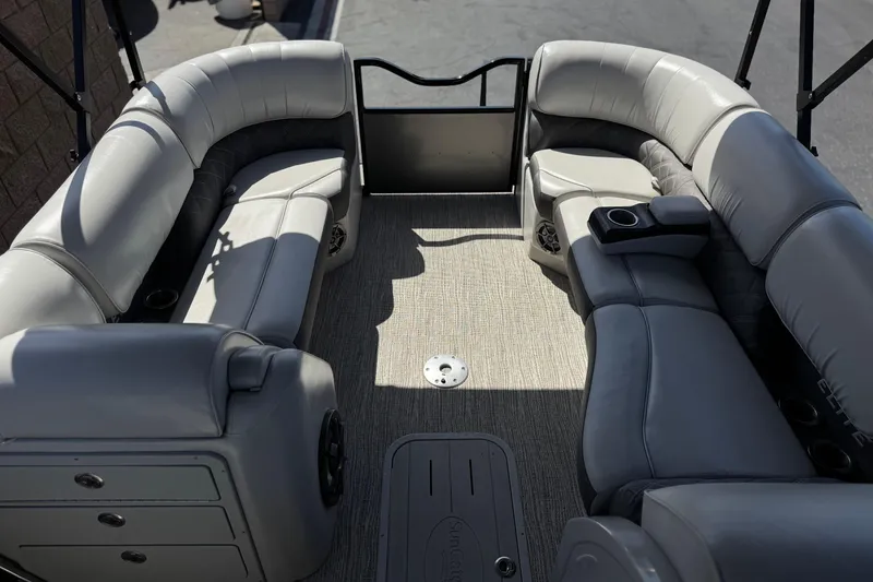 Slide: The Image of 2023 SunCatcher Elite 326 SE boat interior with gray seating and cup holders. - 11