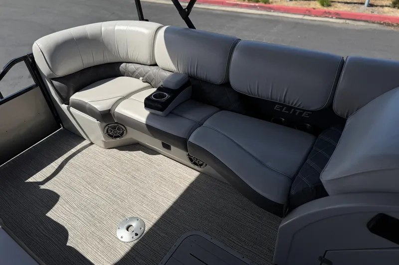 Slide: The Image of 2023 SunCatcher Elite 326 SE boat interior with plush seating and cup holders. - 17