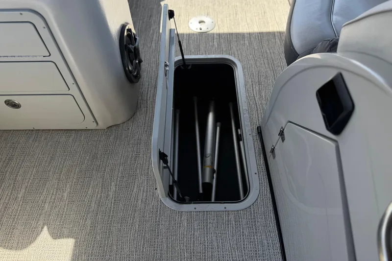 Slide: The Image of 2023 SunCatcher Elite 326 SE boat storage compartment with open hatch and visible interior. - 18