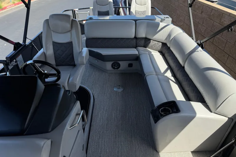 Slide: The Image of 2023 SunCatcher Elite 326 SE boat interior with plush seating and steering console. - 19