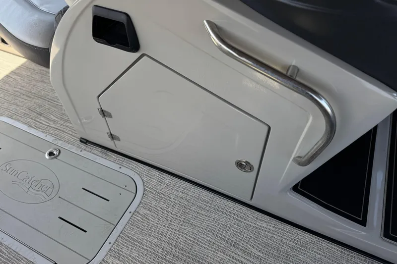 Slide: The Image of 2023 SunCatcher Elite 326 SE boat interior with storage compartment and handle. - 28
