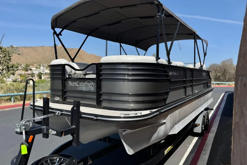 Slide: The Image of 2023 SunCatcher Elite 326 SE pontoon boat on trailer, featuring sleek design and canopy. - 3