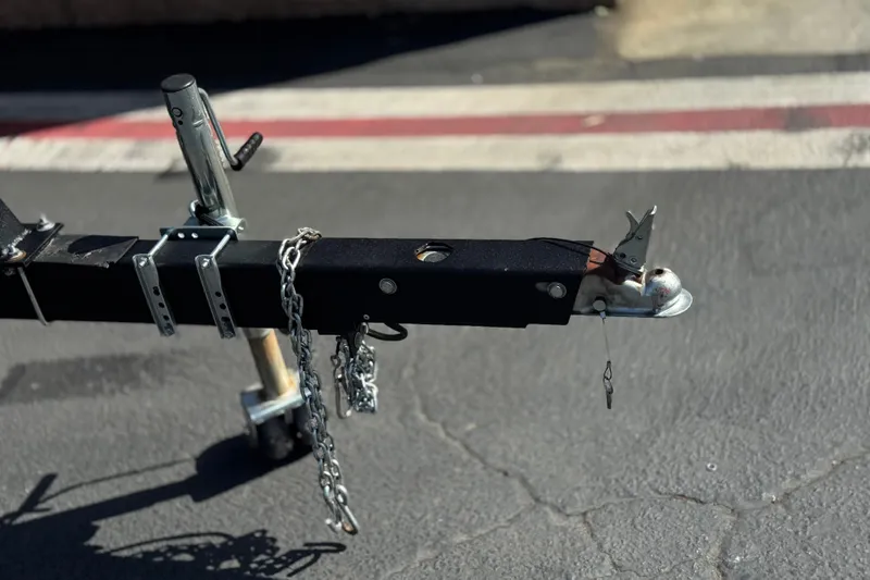 Slide: The Image of Trailer hitch of a 2023 SunCatcher Elite 326 SE on asphalt pavement. - 31