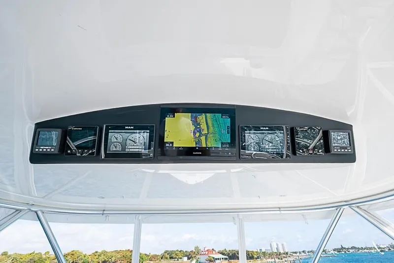 Slide: The Image of 2026 Viking 54 Convertible navigation system with multiple screens. - 18
