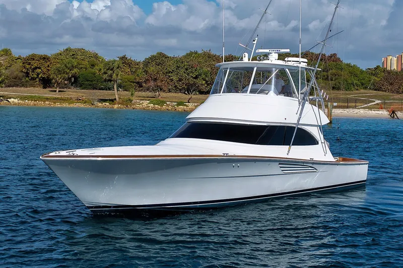 Slide: The Image of 2026 Viking 54 Convertible Yacht on calm waters. - 2