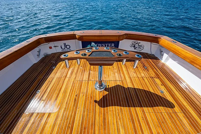 Slide: The Image of Viking 54 Convertible 2026 with sleek wooden deck on open sea. - 6