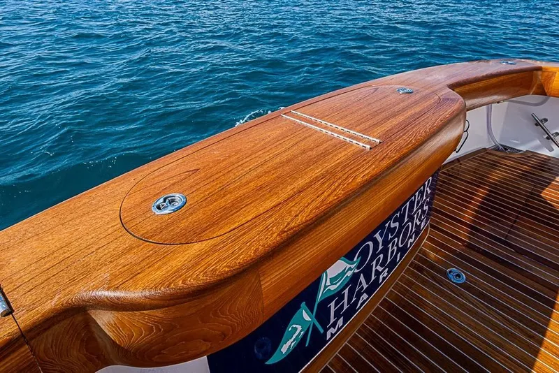 Slide: The Image of Viking 54 Convertible 2026 with polished wood deck on open sea. - 7
