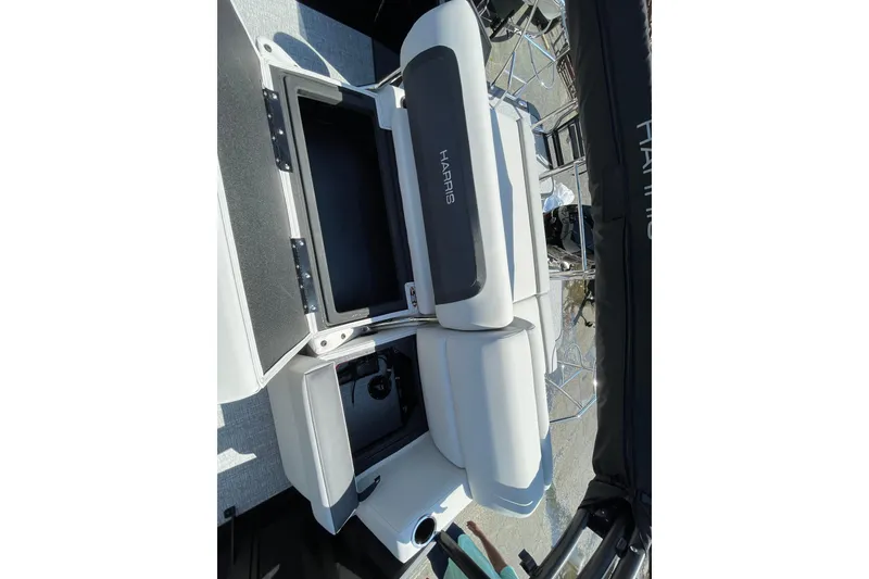 Slide: The Image of 2026 Harris Cruiser 230 SLDH boat interior with open storage compartment. - 10
