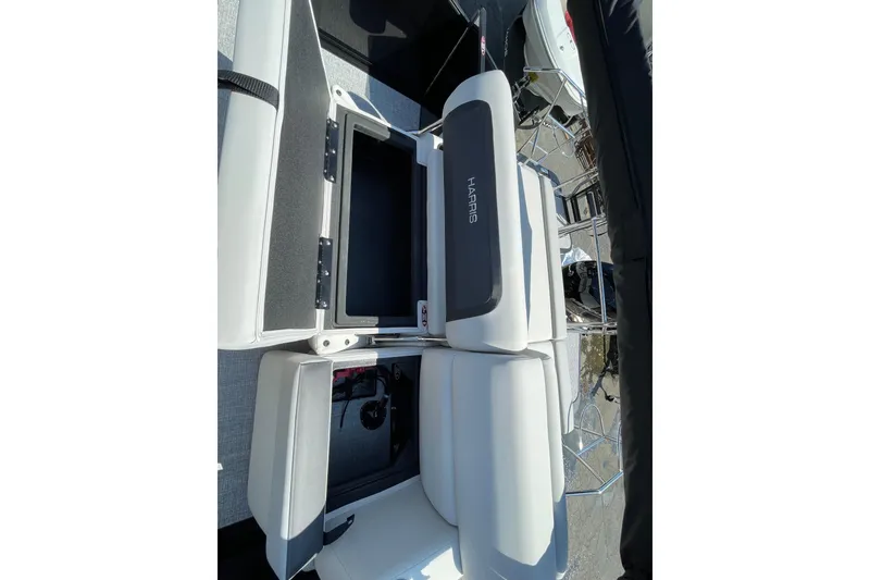 Slide: The Image of 2026 Harris Cruiser 230 SLDH boat interior with open storage compartments and seating. - 11