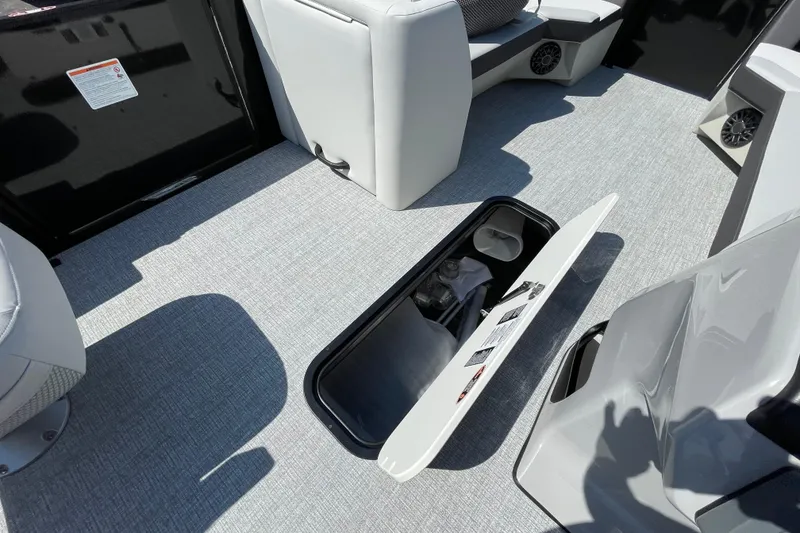 Slide: The Image of Interior of 2026 Harris Cruiser 230 SLDH with open storage compartment. - 13
