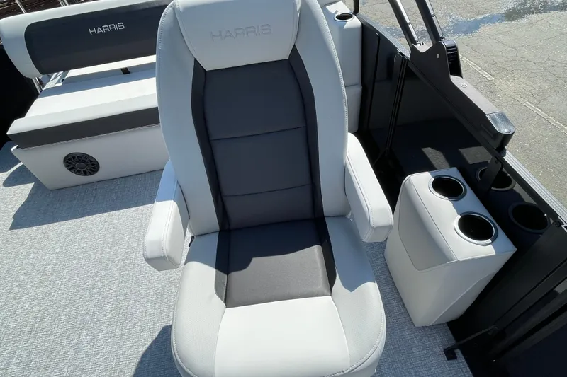 Slide: The Image of 2026 Harris Cruiser 230 SLDH boat interior with plush seating and cup holders. - 14