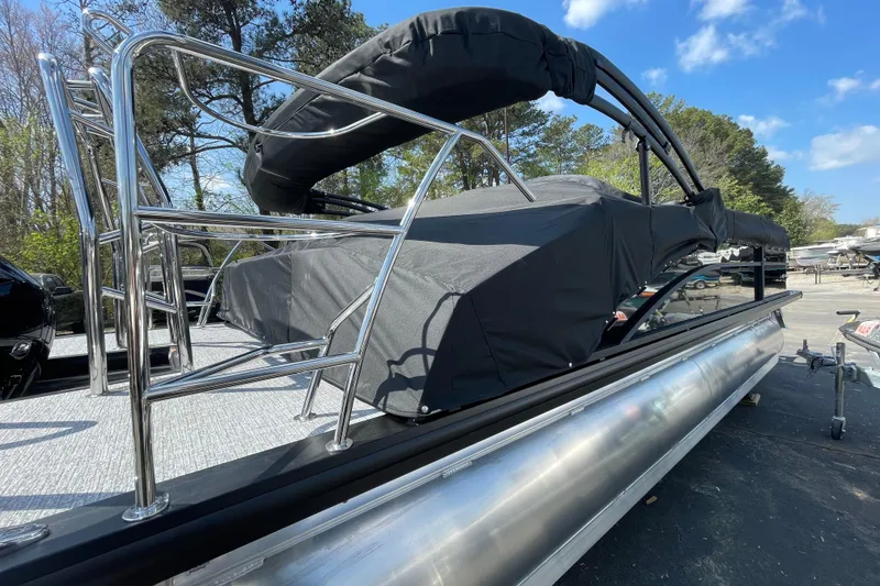 Slide: The Image of 2026 Harris Cruiser 230 SLDH pontoon boat with sleek design and protective cover. - 16