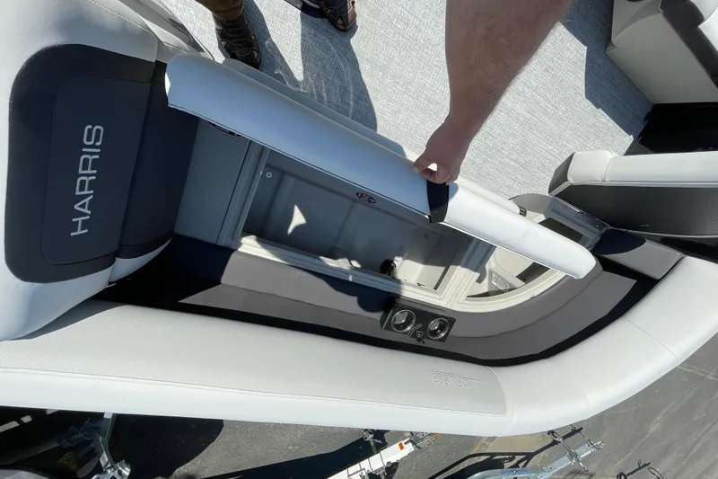 Slide: The Image of 2026 Harris Cruiser 230 SLDH boat interior with storage compartment and cup holders. - 5