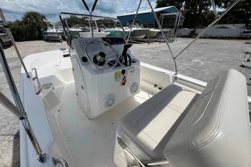 Slide: The Image of 2023 Boston Whaler 150 Montauk boat interior with steering console and seating. - 10