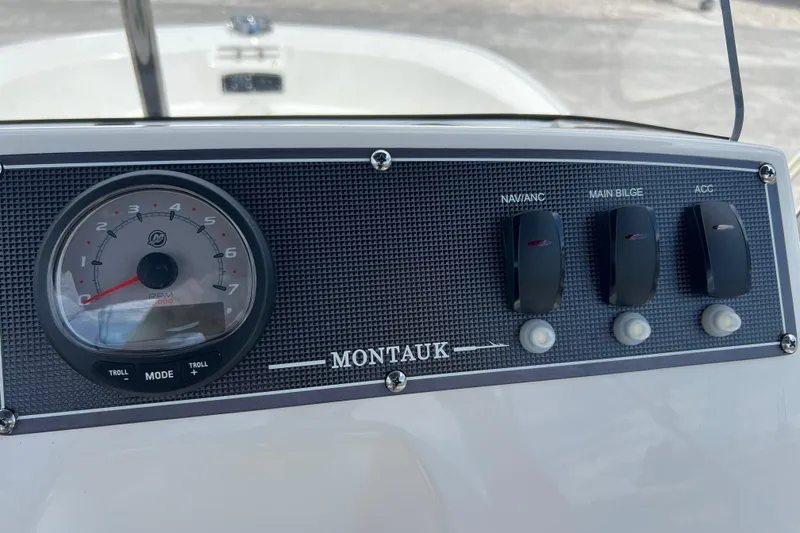Slide: The Image of Control panel of 2023 Boston Whaler 150 Montauk boat with RPM gauge and switches. - 15