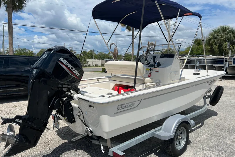 Slide: The Image of 2023 Boston Whaler 150 Montauk boat with Mercury engine on trailer. - 7