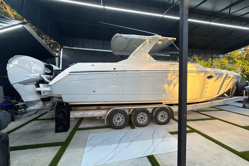 The Image of 2005 Formula 330 Sun Sport boat on trailer in covered storage area. - 1