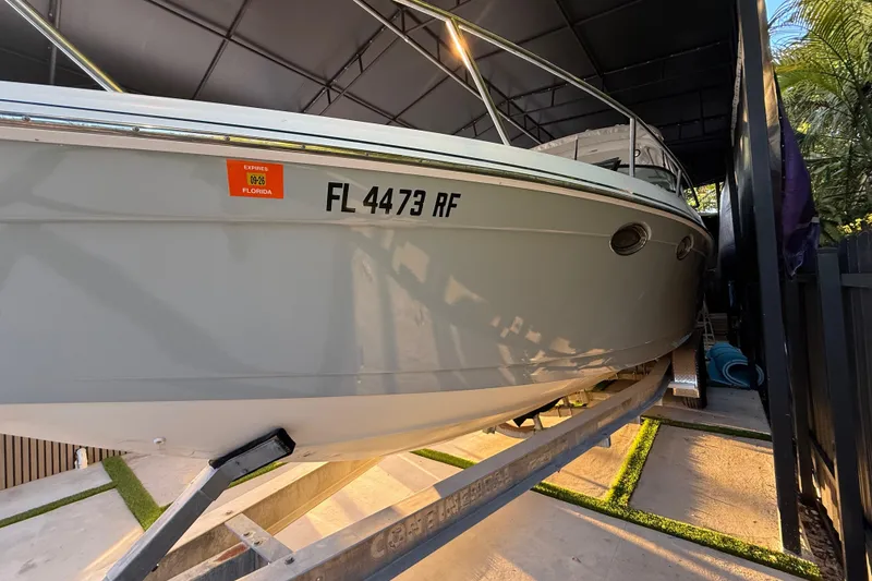 Slide: The Image of 2005 Formula 330 Sun Sport boat on trailer, Florida registration visible. - 10